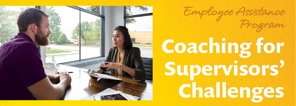 Man and woman meet at table near windows against a mottled yellow background with text to the right: Employee Assistance Program, Coaching for Supervisors' Challenges