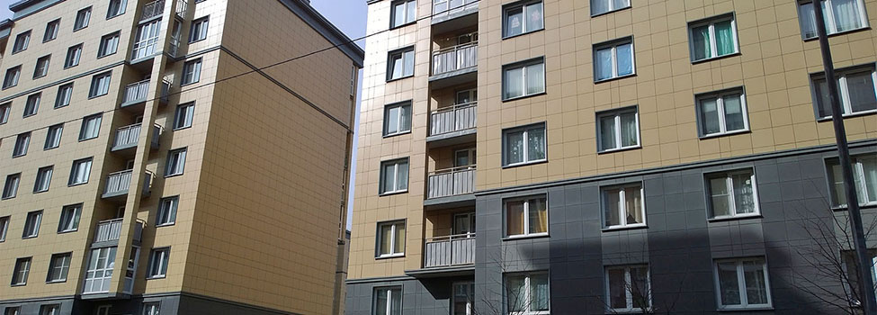 Facade of a new multi-story residential building. Rising prices for the purchase, sale and rental of real estate. Economy class apartments and comfortable housing. Cityscape. City living. Stay at home