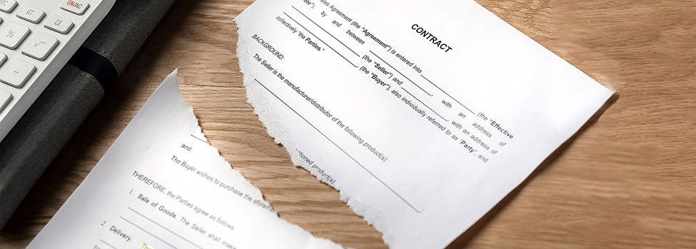 Contract terminated concept. Hands breaching and ripping legal business agreement.