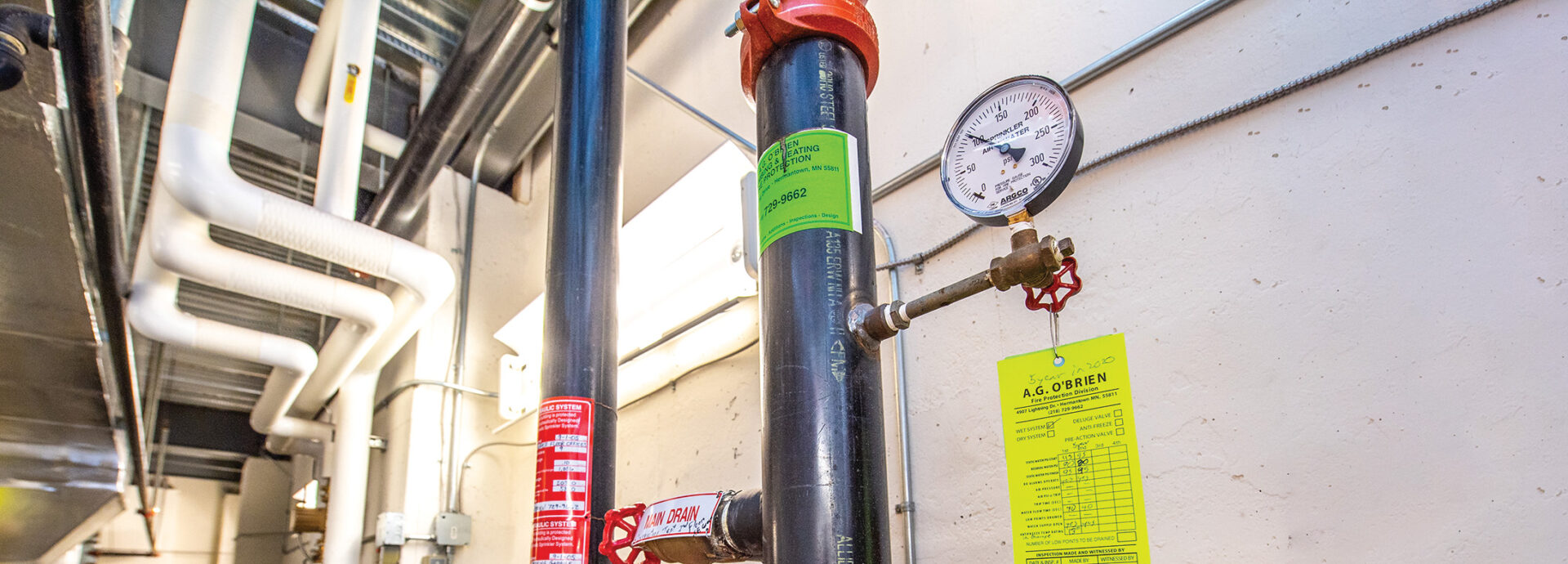 Water pipes and pressure gauge in a commercial building